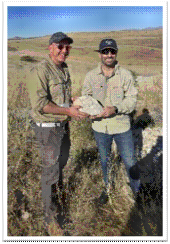 A couple of men holding a rock AI-generated content may be incorrect.